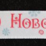 Атласная лента подарочная 15 мм. Цвет белый с надписью "Теплого Нового года!"